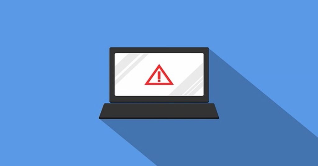 a laptop computer featuring a warning symbol on the screen is ahown against a bright blue background to symbolize a ransomware attack