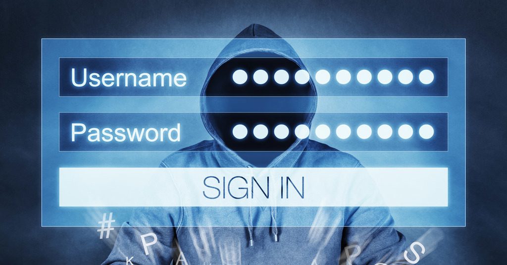 a man in a hoodie is shown with a login screen superimposed to represent passwords for sale on the Dark Web