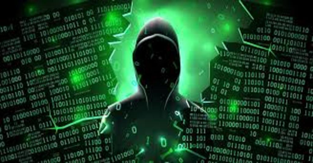 facts about cybersecurity in 2020 on the Dark Web represented by a creepy figure in a hoodie on a green and black code background.