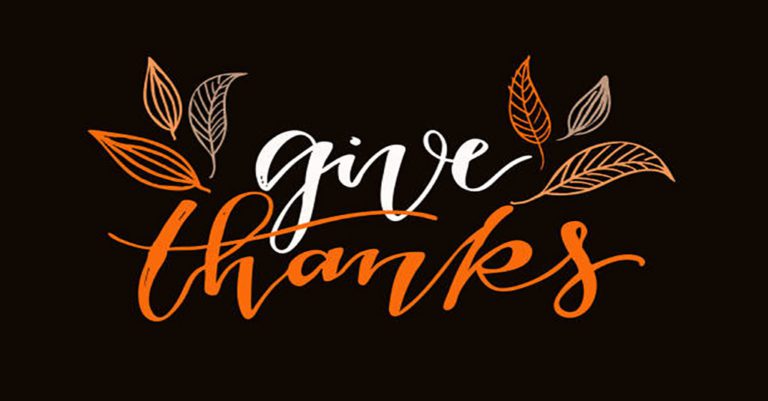 give thanks in orange and beige surrounded by leaves in script on a black background.