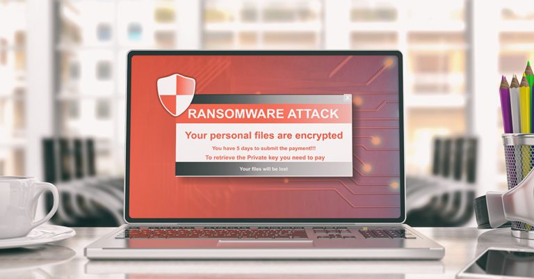 north korean hackers charged in wannacry ransomware depicted as a computer screen on a modern desk with a red warning that files have been encrypted.